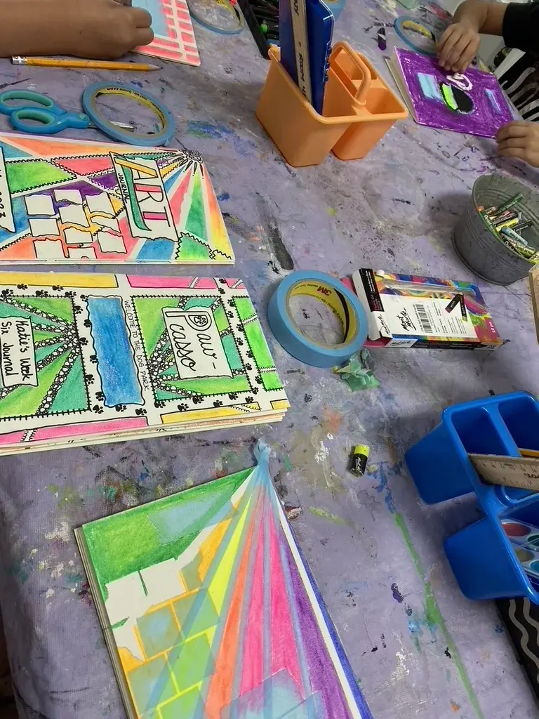 Summer camp table filled with art projects